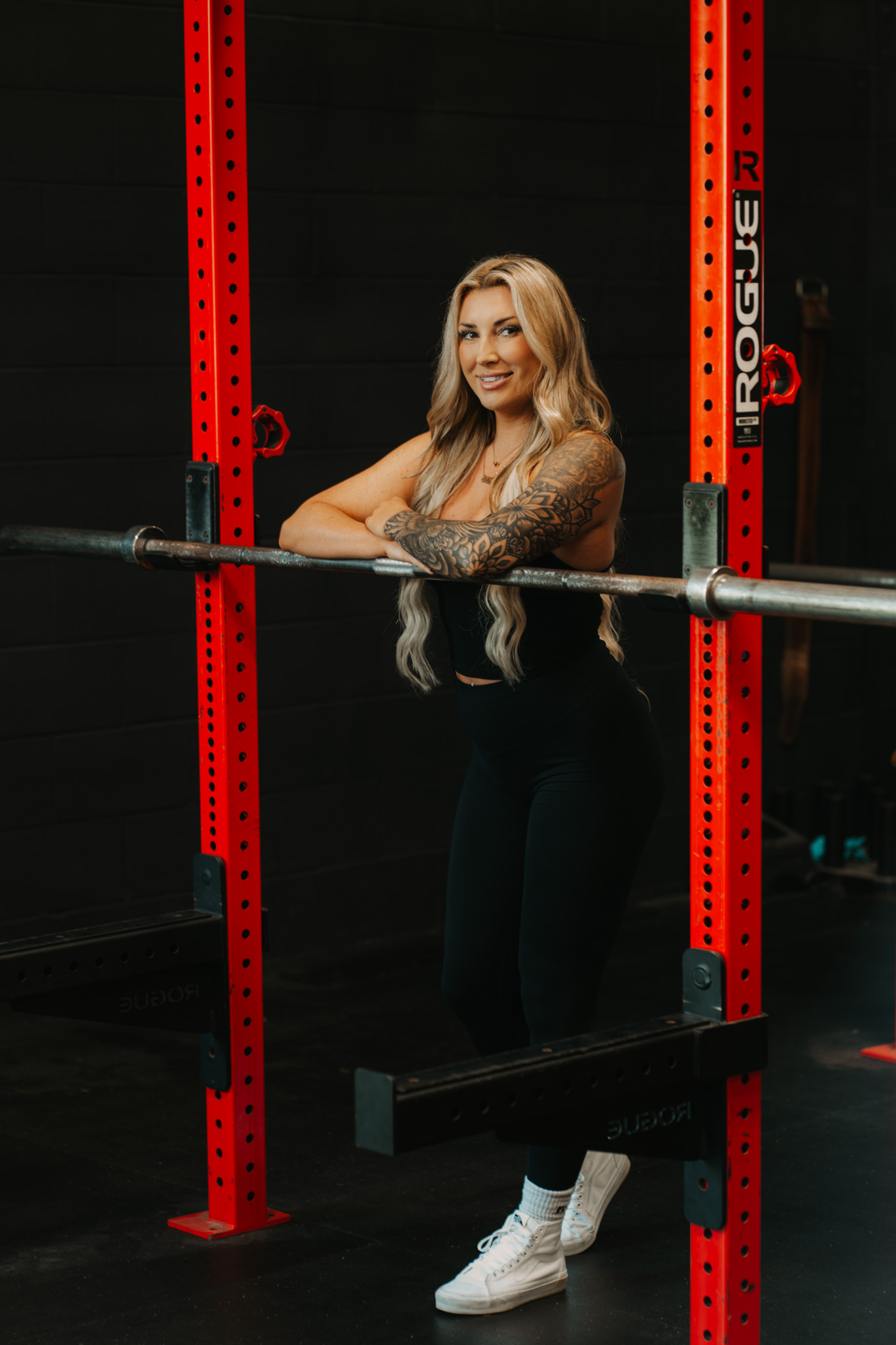 Coach Jamie smiling at the squat rack
